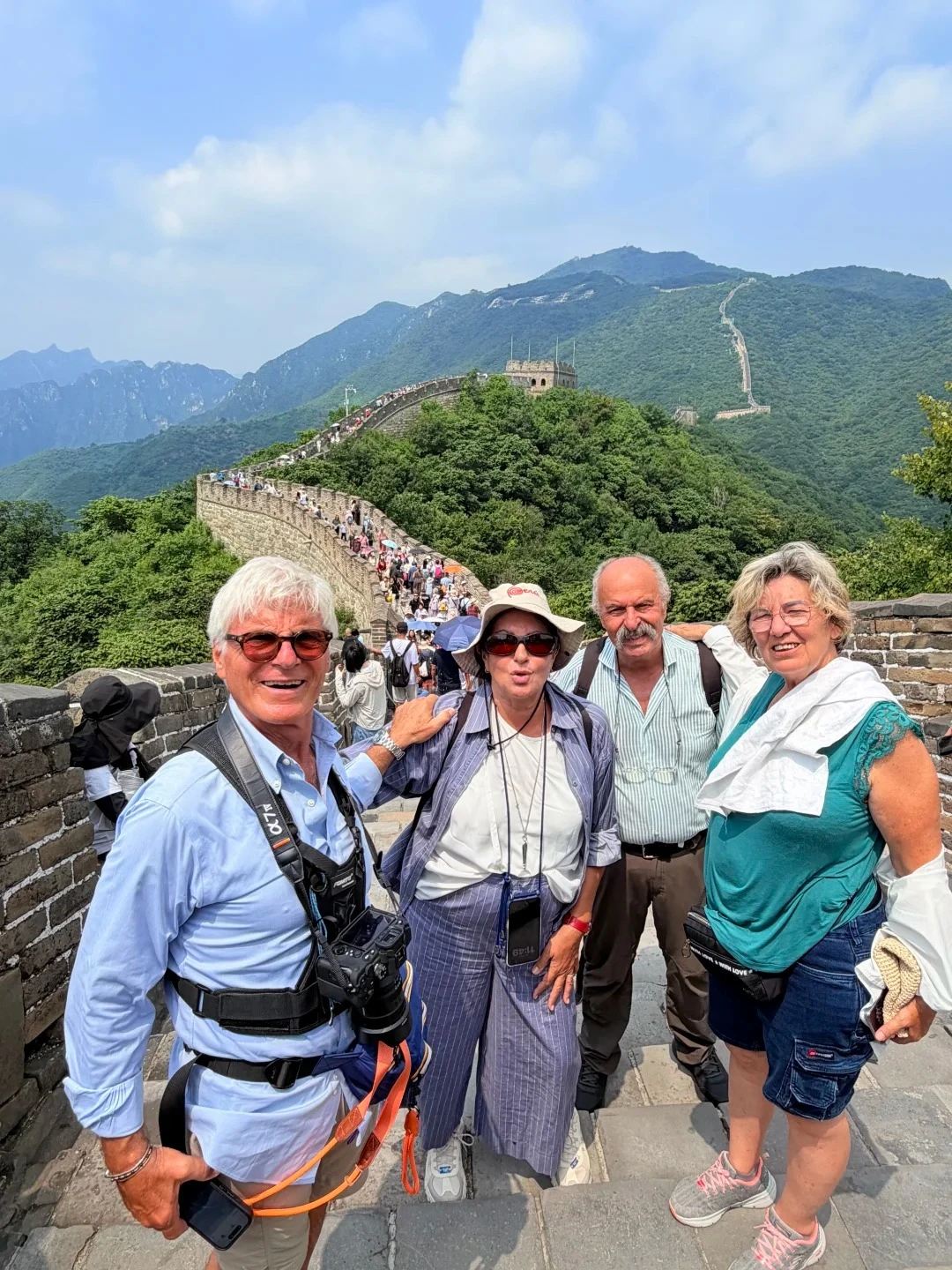 Travelers on a Great Wall walkway with the wall climbing green mountain ridges — private pacing for a Beijing day